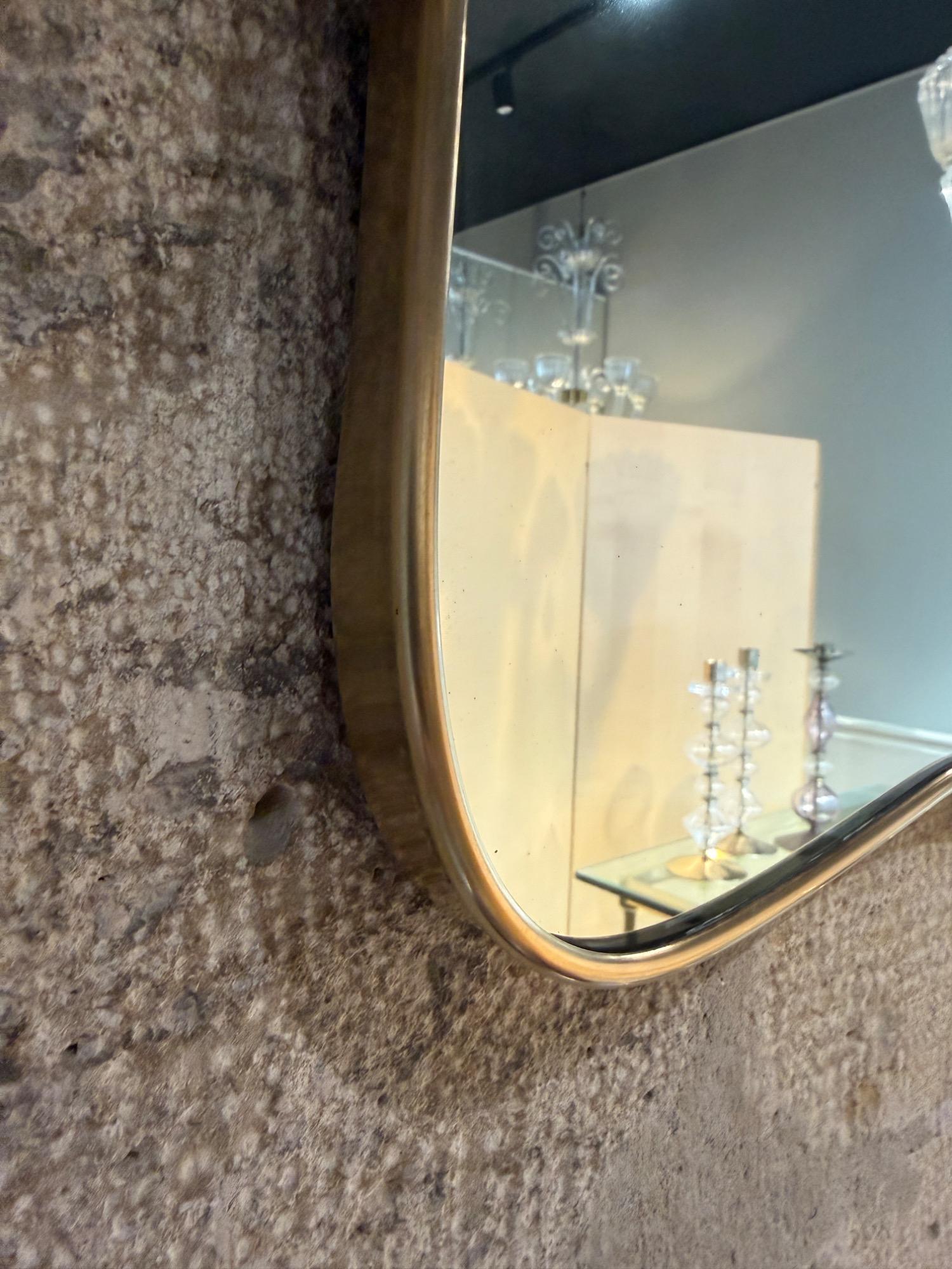 Italian brass mirror with sconces circa 1950